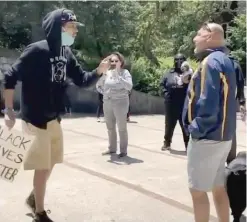  ??  ?? SEE VIDEO AT SUNTIMES.COM: A man identified as retired Cook County Judge Robert Bertucci takes a swing Saturday at a protester near the Christophe­r Columbus statue in Little Italy.