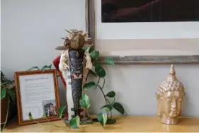  ?? STAFF FILE PHOTO ?? A shaman doll is displayed next to a bust of Buddha at the Center for Mindful Living. The center will close its physical space and move programmin­g online after revenue losses during the coronvirus pandemic.