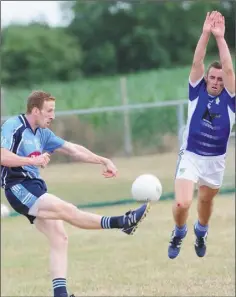  ??  ?? Liam Carthy, Roche Emmets, attempts to block down a shot by Gareth Moran.