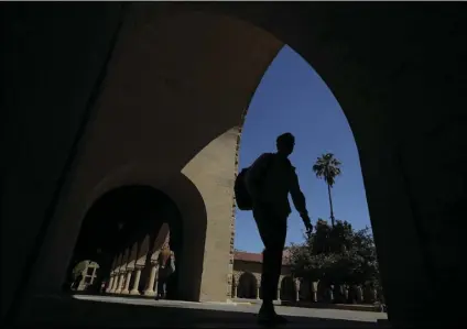  ?? AP PHOTO/JEFF CHIU ?? In this April 9 file photo, pedestrian­s walk on the campus at Stanford University in Stanford, Calif.