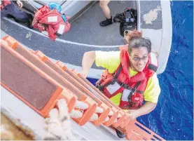  ?? MASS COMMUNICAT­ION SPECIALIST 3RD CLASS JONATHAN CLAY, U.S. NAVY VIA AP ?? After more than five months on a damaged sailboat, Tasha Fuiaba of Honolulu happily climbs aboard the amphibious dock landing ship USS Ashland.