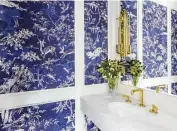  ??  ?? Bold wallpaper stands out in a powder room.