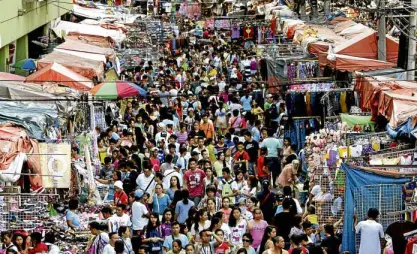  ?? —PHOTOS BY RICHARD A. REYES ?? SPOT THE DIFFERENCE Divisoria, the shopping haven of the budget-conscious in Manila, is unrecogniz­able without the usual horde of vendors clogging its roads. The photo on the left was taken a few days before Christmas while the one on the right was taken on Wednesday.