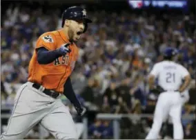  ?? DAVID J. PHILLIP — THE ASSOCIATED PRESS ?? The Houston Astros’ George Springer reacts after hitting a two-run home run during the second inning of Game 7of baseball’s World Series against the Los Angeles Dodgers Wednesday in Los Angeles.