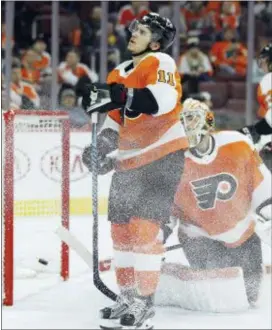  ?? TOM MIHALEK — THE ASSOCIATED PRESS ?? The Flyers’ Travis Konecny, left, and goalie Michal Neuvirth react goal by Pittsburgh’s Riley Sheahan’s during the third period. to a