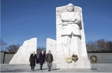  ?? SARAH SILBIGER The New York Times ?? President Donald Trump, center, with Vice President Mike Pence, left, and acting interior secretary David Bernhardt visit the Martin Luther King Jr. Memorial in Washington, D.C. on Monday, laying wreaths in front of the massive structure.