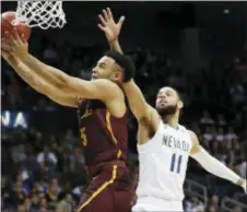  ?? DAVID GOLDMAN — THE ASSOCIATED PRESS ?? Loyola-Chicago guard Marques Townes (5) moves to the hoop as Nevada forward Cody Martin (11) defends during the second half of a regional semifinal NCAA college basketball game on Thursday in Atlanta.
