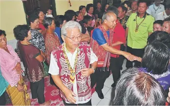  ??  ?? Masing (centre) greeting the residents of Rumah Lindang together with Masir (behind Masing) upon their arrival at the event yesterday.