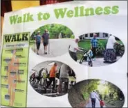  ?? MICHILEA PATTERSON — DIGITAL FIRST MEDIA ?? A poster displayed inside the Sanatoga Ridge community center displays the benefits of walking. A group from the retirement facility called Trail Blazers walk through the neighborho­od on Wednesday afternoons.