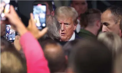  ?? Photograph: Scott Olson/Getty Images ?? Donald Trump greets guests at a campaign rally at an automotive parts manufactur­er in Clinton Township, Michigan, on Wednesday.