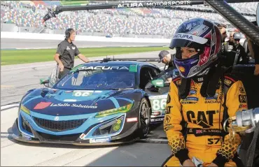  ?? MARK LONG PHOTOS / AP ?? Katherine Legge of England waits to drive during a test session at Daytona Internatio­nal Speedway in Daytona Beach, Fla. Legge is part of an all-female driver team racing in the Rolex 24 at Daytona later this month.