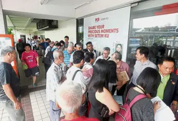  ??  ?? Selling like hot cakes: The public waiting in line to buy the limited edition stamps of Dr Mahathir at Pos Malaysia in Kuala Lumpur.