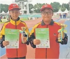  ??  ?? Girls U-12 200m gold medallist Karen Rejie and Albert Tiong, the Boys U-12 shot put new record holder, were named Best Athlete in the U-12 category.