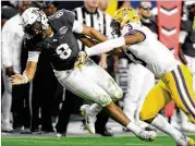  ?? NORM HALL / GETTY IMAGES ?? LSU safety JaCoby Stevens hits UCF quarterbac­k Darriel Mack Jr. during the fourth quarter Tuesday. The Tigers sacked Mack five times.