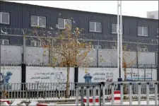  ?? NG HAN GUAN — THE ASSOCIATED PRESS FILE ?? In this file photo, two layers of barbed wire fencing ring the “Hotan City apparel employment training base” where Hetian Taida Apparel Co. has a factory in Hotan in western China’s Xinjiang region.