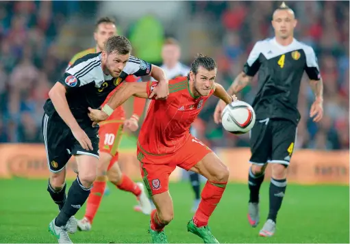  ?? AFP ?? Belgium’s Nicolas Lombaerts vies with Wales’s midfielder Gareth Bale (right) during the Euro 2016 qualifying Group B match. —