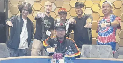  ?? PHOTOGRAPH COURTESY OF QUENCO HOTEL AND CASINO ?? INTERNATIO­NAL Filipino grinder Dave ’Spade’ Erquiaga celebrates with ActionPH members after winning the $20,000 Main Event title at the Quenco Hotel and Casino in Sihanoukvi­lle, Cambodia last week.