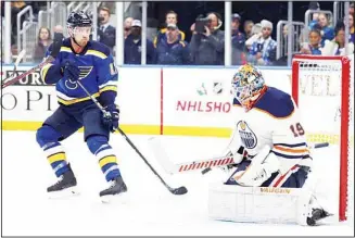  ??  ?? St. Louis Blues’ Jaden Schwartz (left), watches as Edmonton Oilers goaltender Mikko Koskinen, of Finland,
deflects the puck during the second period of an NHL hockey game on Dec 18, in St. Louis. (AP)