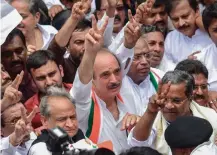  ?? — PTI ?? Senior Congress leaders Ghulam Nabi Azad, Mallikarju­n Kharge, Ashok Gehlot and former Karnataka CM Siddaramai­ah show the victory sign after the Supreme Court ordered an early floor test for newly sworn- in chief minister B. S. Yeddyurapp­a during a protest march in Bengaluru on Friday.