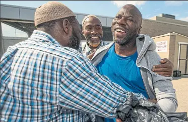  ?? RICK MADONIK/ TORONTO STAR ?? Ebrahim Toure, right, who was profiled as part of the Star’s investigat­ion into Canada’s immigratio­n detention system, is greeted by friends after being released Friday. “It’s something that should have happened a very long time ago,” said Jared Will, Toure’s lawyer.