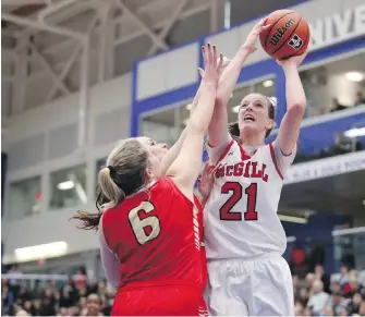  ?? CHAD HIPOLITO, THE CANADIAN PRESS ?? McGill forward Alex Kiss-Rusk goes up over Laval’s Raphaelle Cote during the gold-medal game at UVic’s CARSA gym on Sunday. Kiss-Rusk was named the tournament MVP.