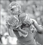  ?? AP/JOHN LOCHER ?? Boise State wide receiver Cedrick Wilson catches a pass over Oregon cornerback Thomas Graham Jr. during the second half of the Las Vegas Bowl on Saturday in Las Vegas. Wilson caught 10 passes for 221 yards and a touchdown to help the Broncos win 38-28.