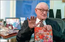  ?? GAO TIANPEI / CHINA DAILY ?? Nicholas Platt holds a photo book, published by China Daily, celebratin­g the 70th anniversar­y of the founding of New China, during an interview in his New York office on Oct 3.