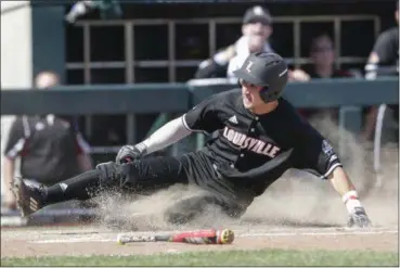  ?? NATI HARNIK — THE ASSOCIATED PRESS ?? Louisville’s Ryan Summers scores on a single by Colby Fitch, who later advanced to second base on an error, in the eighth inning of a College World Series game against Texas A&M on June 18 in Omaha, Neb. Louisville won, 8-4.