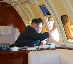  ??  ?? This picture from North Korea’s official Korean Central News Agency (KCNA) taken on May 8 and released on May 9 shows Kim Jong Un waving to Chinese officials from his plane before departing the Chinese city of Dalian. — AFP photo