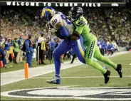  ?? Lindsey Wasson / Getty Images ?? Rams tight end Tyler Higbee hauls in a third quarter touchdown reception against Seahawks safety Jamal Adams on Thursday night at Lumen Field in Seattle.