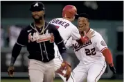  ?? ALEX BRANDON — THE ASSOCIATED PRESS ?? Washington’s Juan Soto, right, and Trea Turner celebrate behind Atlanta second baseman Ozzie Albies after Soto hit a game-winning single in the ninth inning in Washington.