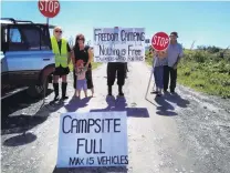  ?? PICTURE: SUPPLIED ?? Keep away . . . Kakapotahi and Pukekura residents picket the Beach Rd camp, at Waitaha, as they take action to limit the number of freedom campers parking up each night.