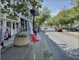  ?? JUSTIN COUCHOT/MERCURY-REGISTER ?? California state flags fly outside of Oroville businesses on California Admission Day on Thursday on Montgomery Street in Oroville.