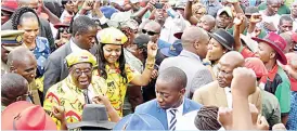  ??  ?? President Mugabe and First Lady Dr Grace Mugabe make their way through a dense crowd of supporters at the Zanu-PF headquarte­rs in Harare yesterday