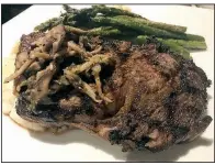  ??  ?? Arkansas Democrat-Gazette/JENNIFER CHRISTMAN A rib-eye is served with a mushroom relish, mashed potatoes and asparagus at Ira’s Restaurant in downtown Little Rock.