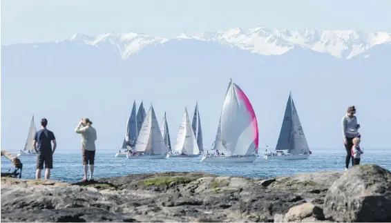  ??  ?? Spectators watch the start of the Swiftsure Internatio­nal Yacht Race at Clover Point last year.