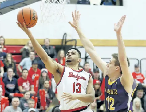  ?? BOB TYMCZYSZYN/STANDARD STAFF ?? Brock's Dani Elgadi, No. 13, going up for a basket in men's university basketball versus Laurier in this file photo, is the school's male athlete of the week.