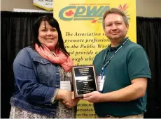  ??  ?? City of Moose Jaw public work supervisor Staci Dobrescu receives the Harry S. Swearingen Award for individual achievemen­t in support of the American Public Works Associatio­ns strategic plans, goals and objectives from SPWA president Dale Petrun.