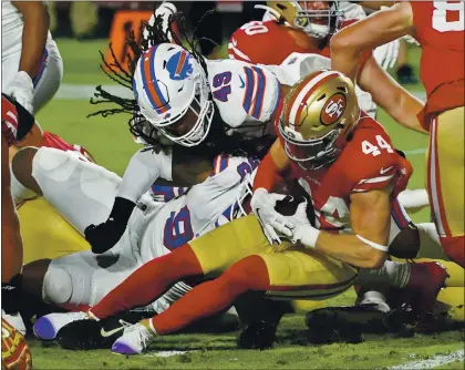  ?? RICK SCUTERI — THE ASSOCIATED PRESS ?? Fullback Kyle Juszczyk runs into a brick wall of Bills defenders at the goal line, led by Buffalo middle linebacker Tremaine Edmunds (49).