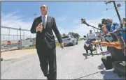  ??  ?? Tony Spell, pastor of the Life Tabernacle Church, walks to his church bus Tuesday as he leaves the East Baton Rouge Parish jail after posting bond.
(AP/Gerald Herbert)