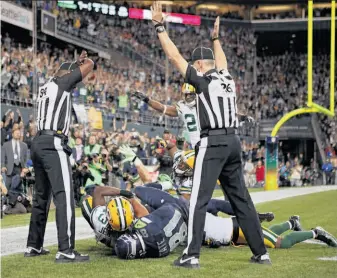  ?? Otto Greule Jr. / Getty Images ?? The replacemen­t officials’ poor decision that decided Monday night’s Packers-Seahawks game cost gamblers up to $250 million, but more importantl­y, cost the NFL its integrity.