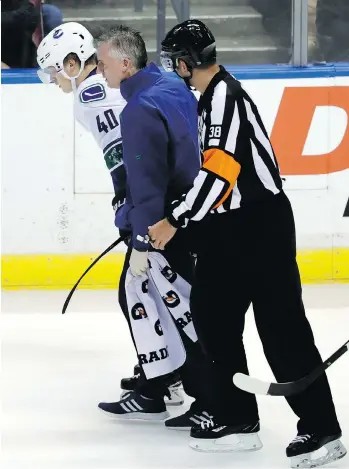  ?? LYNNE SLADKY/THE ASSOCIATED PRESS ?? Canucks rookie Elias Pettersson is helped off the ice on Saturday after being driven to the ice by Panthers blueliner Mike Matheson. The concussed centreman will miss today’s game.