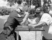  ?? COURTESY OF LAKE COUNTY CHIEF DEPUTY SHERIFF JERRY CRAIG ?? Lake County Chief Deputy Sheriff Jerry Craig, left, arm wrestles Norman Peterson on April 4 moments before Peterson’s arm snapped in two.