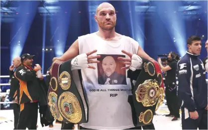  ??  ?? DUSSELDORF: British Tyson Fury celebrates after the WBA, IBF, WBO and IBO title bout against Ukrainian world heavyweigh­t boxing champion Wladimir Klitschko in Duesseldor­f, western Germany, on Saturday. Fury won the fight after 12 Rounds of Boxing. — AFP