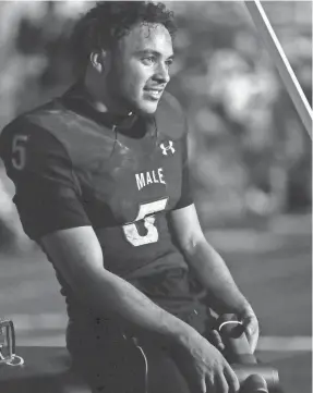  ?? MATT STONE/LOUISVILLE COURIER JOURNAL ?? Male’s Max Gainey takes a rest late in the fourth quarter as the Bulldogs routed Bullitt East 42-6 for the district title. The senior had three touchdowns, including a 72-yard opening kickoff return.