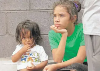  ?? DAVID J. PHILLIP/ AP ?? Angui Funes ( right) sits with her brother, Jesus, after crossing the border back to Reynosa, Mexico, Thursday. The family, who was seeking asylum, said they were told by officials they would be separated, so they voluntaril­y returned to Mexico.