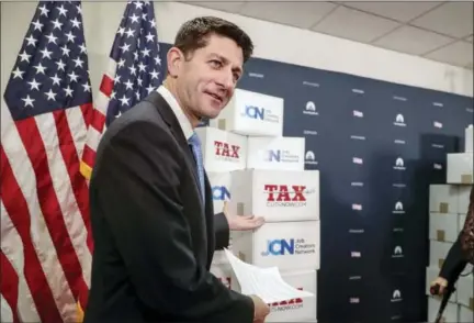  ?? J. SCOTT APPLEWHITE — THE ASSOCIATED PRESS ?? Speaker of the House Paul Ryan, R-Wis., points to boxes of petitions supporting the Republican tax reform bill that is set for a vote later this week as he arrives for a news conference Tuesday on Capitol Hill in Washington.