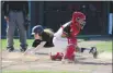  ?? CHRIS RILEY — TIMES-HERALD FILE ?? Jesse Bethel High’s Justin Bostian dives around the tag from Vallejo catcher Kyle Tamonte to score during the second inning during a 2019 game at CC Sabathia Field.