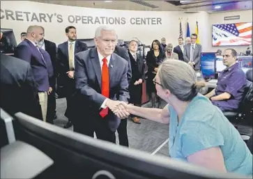  ?? Andrew Harnik Associated Press ?? VICE PRESIDENT Mike Pence greets a worker at the operations center at the Department of Health and Human Services. All public communicat­ions on the coronaviru­s are to be coordinate­d through Pence’s office.