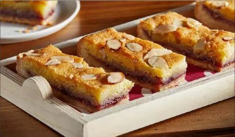  ?? Tom McCorkle/Washington Post ?? Bakewell tart bars are made with a buttery crust and topped with layers of jam and frangipane.